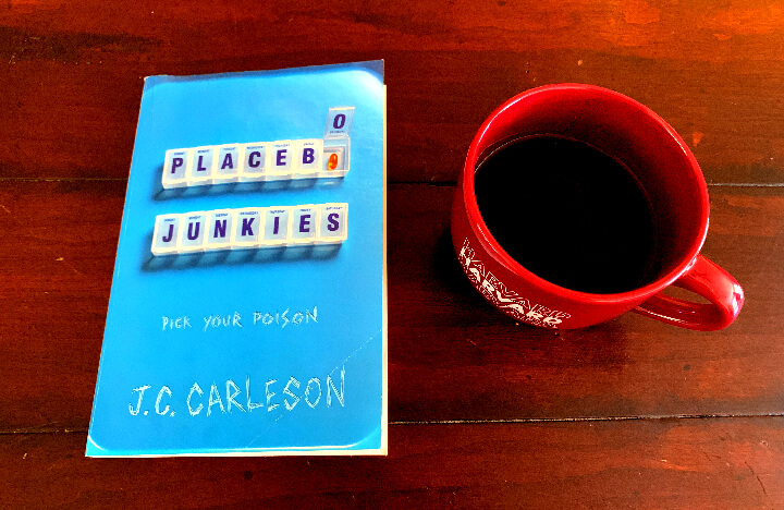 Placebo Junkies by J.C.Carleson 책과 커피잔