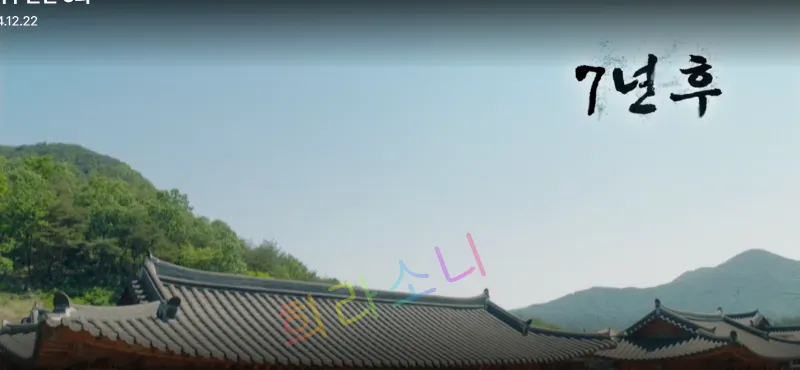 푸른 하늘 아래 전통 기와집이 배경으로 보이고&amp;#44; 오른쪽 위에는 