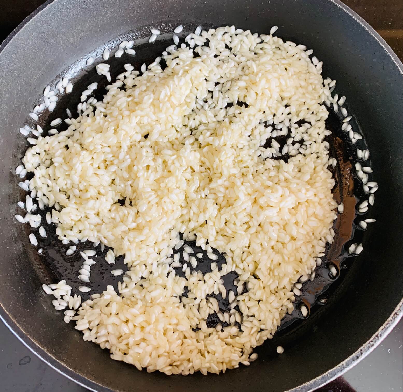검은-팬에-흰-쌀이-올려진-모습