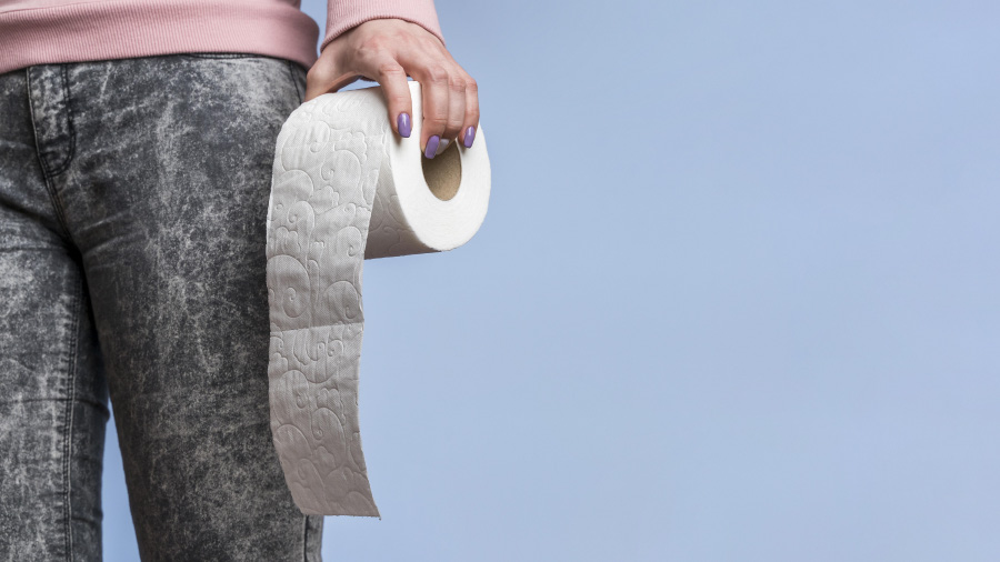 front-view-person-holding-toilet-paper-roll-with-copy-space-900