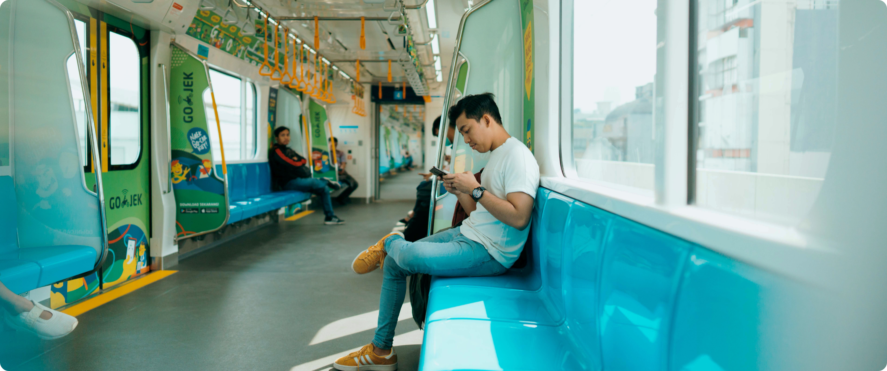 A man using a smartphone on the subway