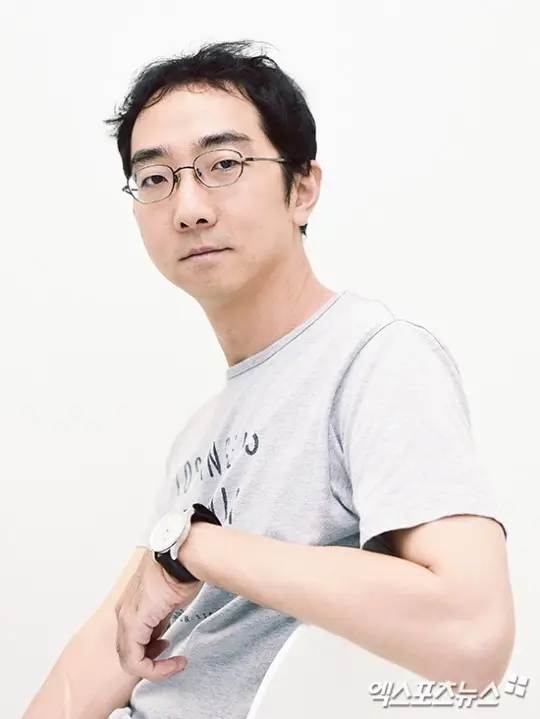 TVN 예능 어쩌다 사장3 메인 피디 유호진
하얀 배경에 안경을 쓰고 연횟개 반팔 티셔츠를 입고 왼손목에 검은색 줄의 시계를 차고 하얀 의자에 비스듬히 앉아 있는 유호진 피디