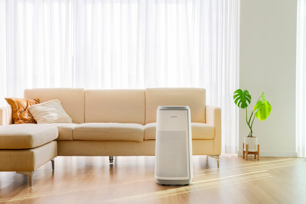 The Cuckoo Inspired air purifier is placed in a modern living room, providing clean air.