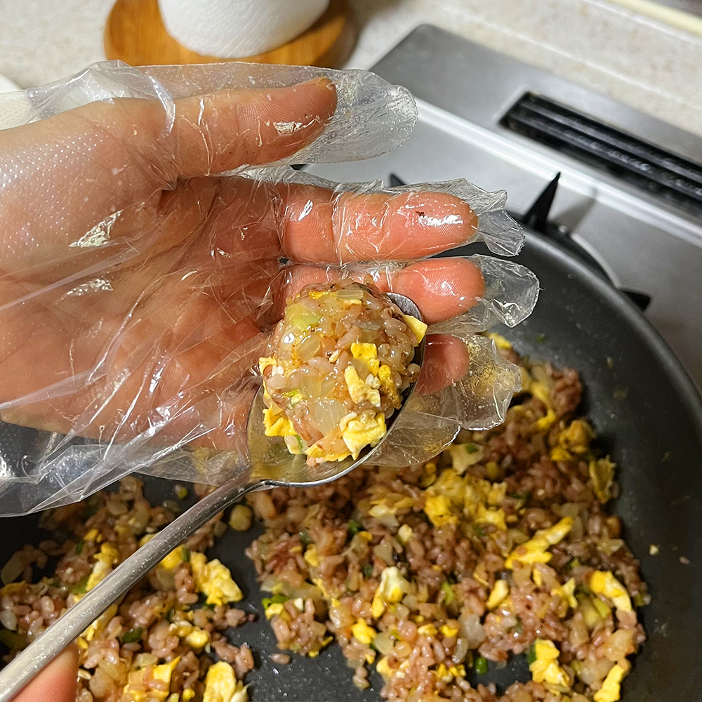 숟가락으로-주먹밥이-놓여있고-비닐장갑-낀-손으로-감싸고-있습니다.(8)