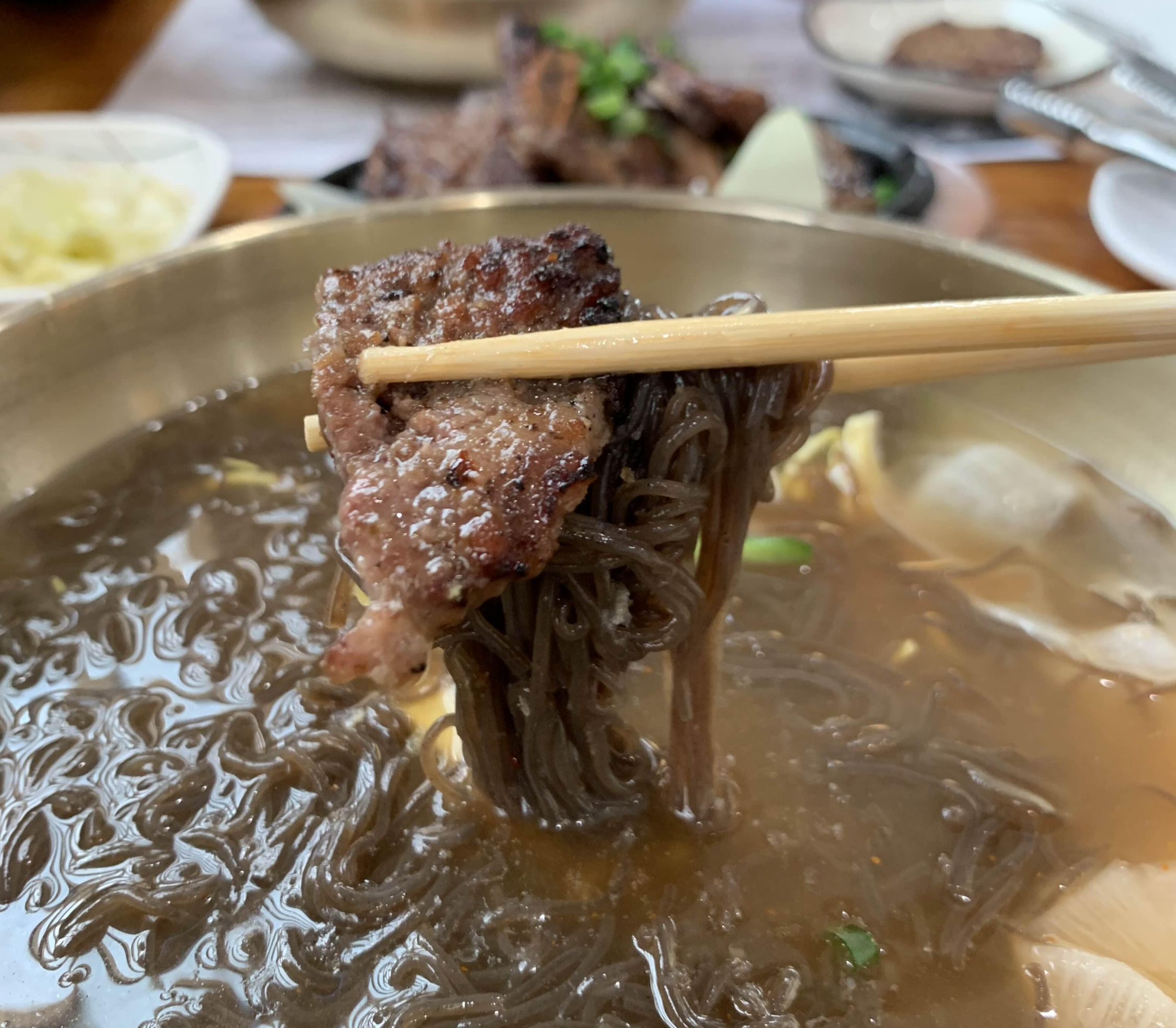 a-bite-of-cold-noodle-with-a-piece-of-galbi