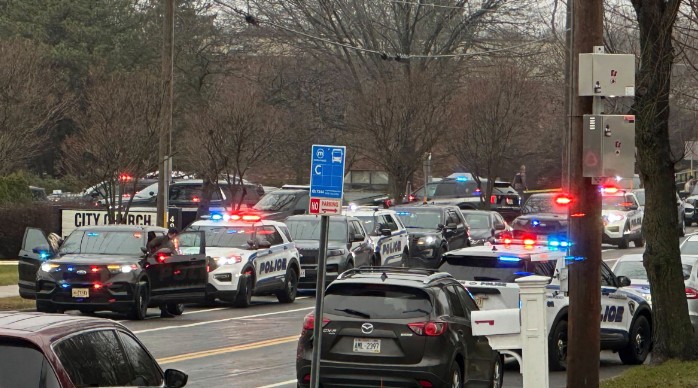 Emergency vehicles are parked outside the Abundant Life Christian School in Madison, Wis., where multiple injuries were reported following a shooting, Monday, Dec. 16, 2024.