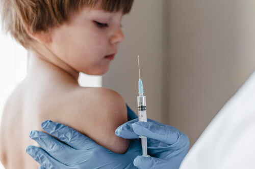 doctor-with-gloves-performing-vaccine-little-child