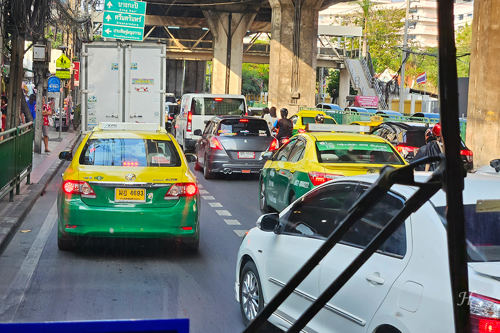 교통 체증 심한 도로 위 노란 택시와 승용차들