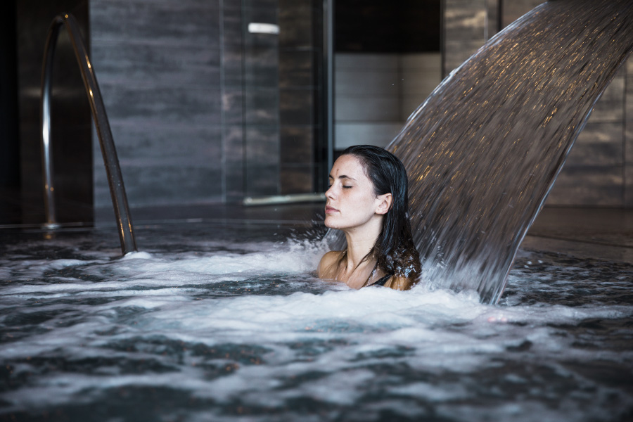 spa-concept-with-woman-relaxing-water-900