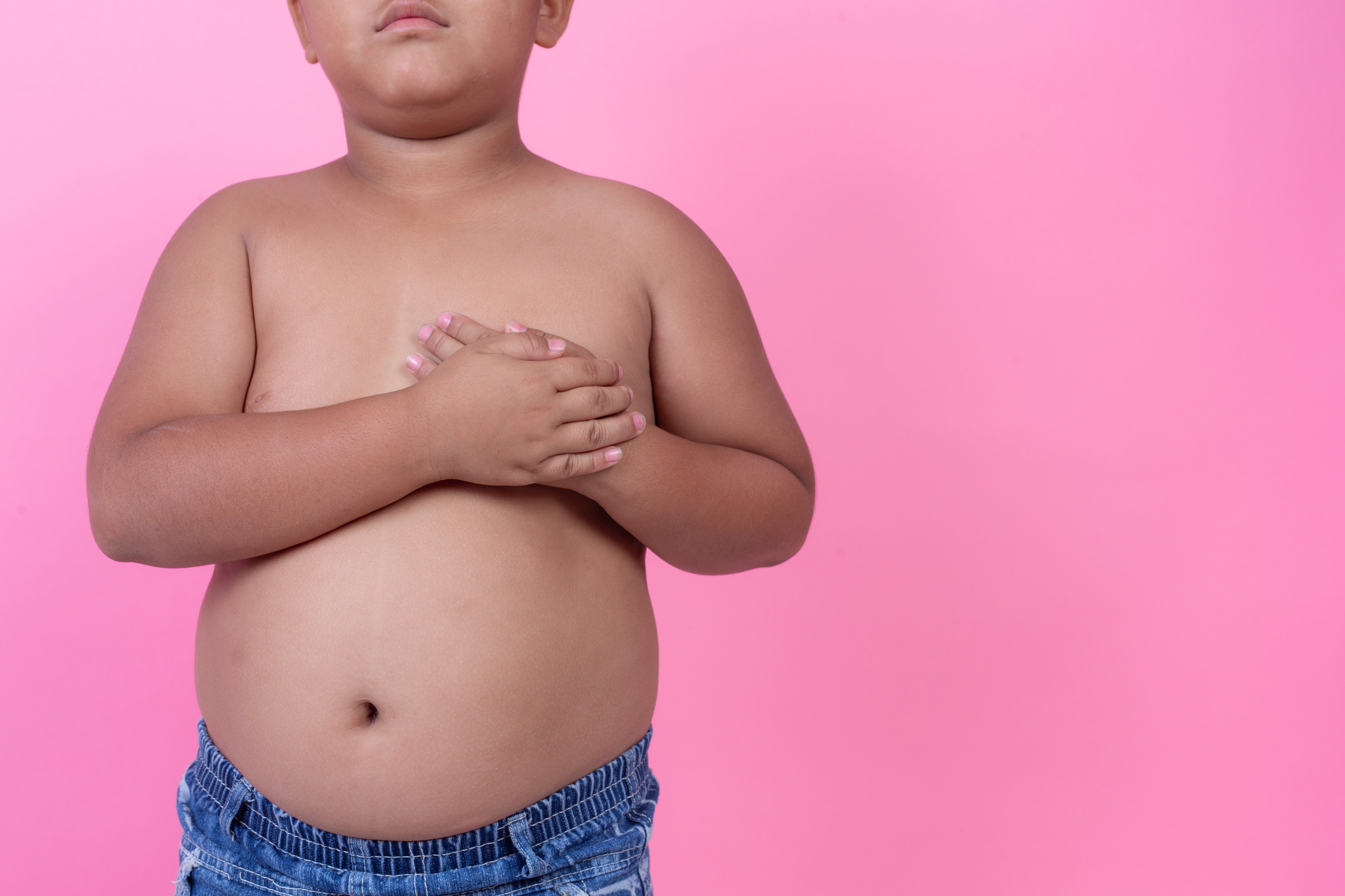 obese-boy-who-is-overweight-pink-background