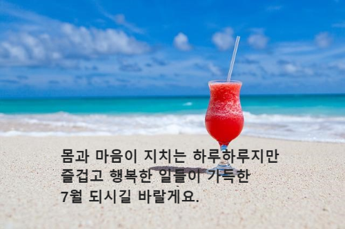 해변 모래사장 위 빨대 꽂은 음료 한잔