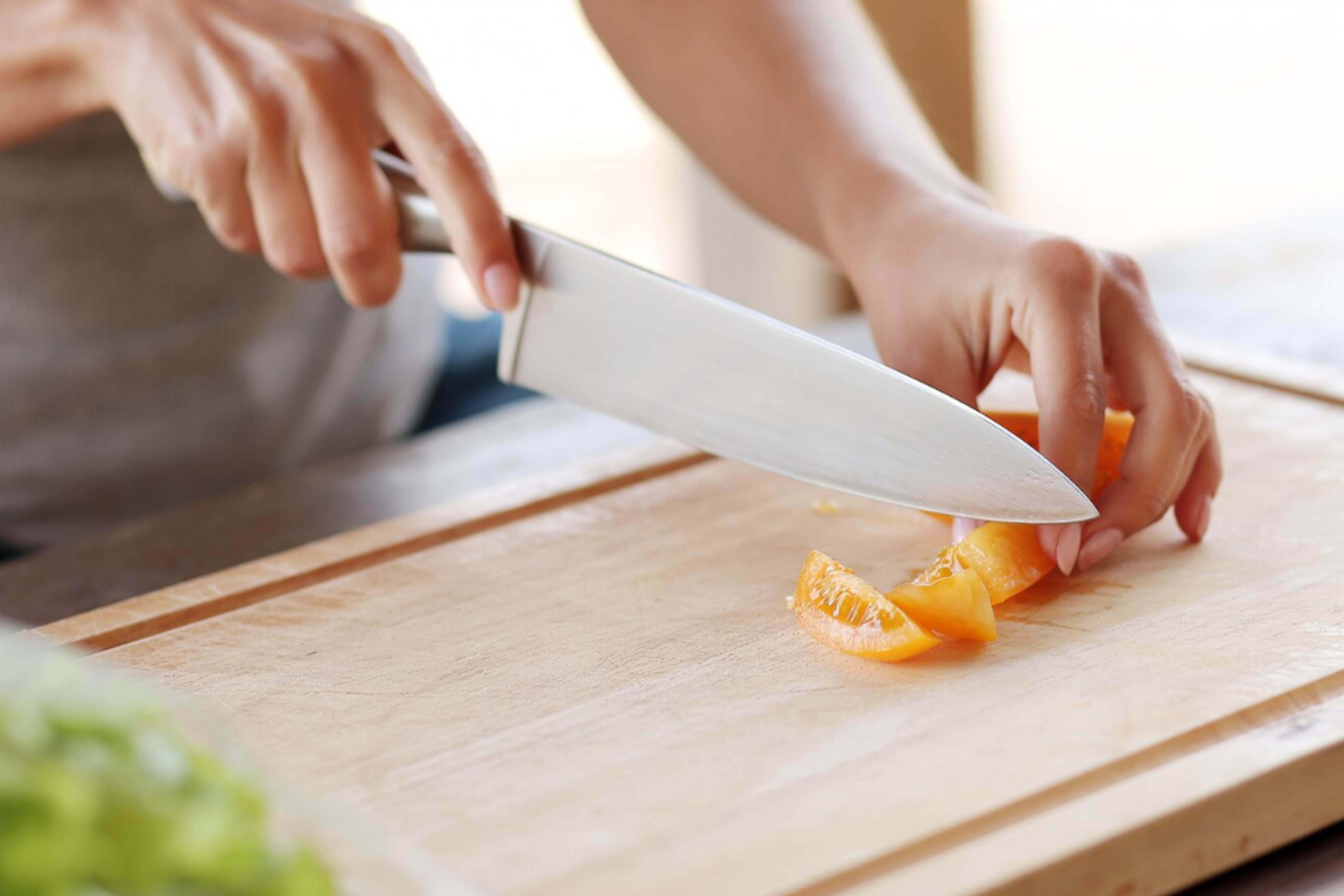 a-person-cooking-with-a-knife.