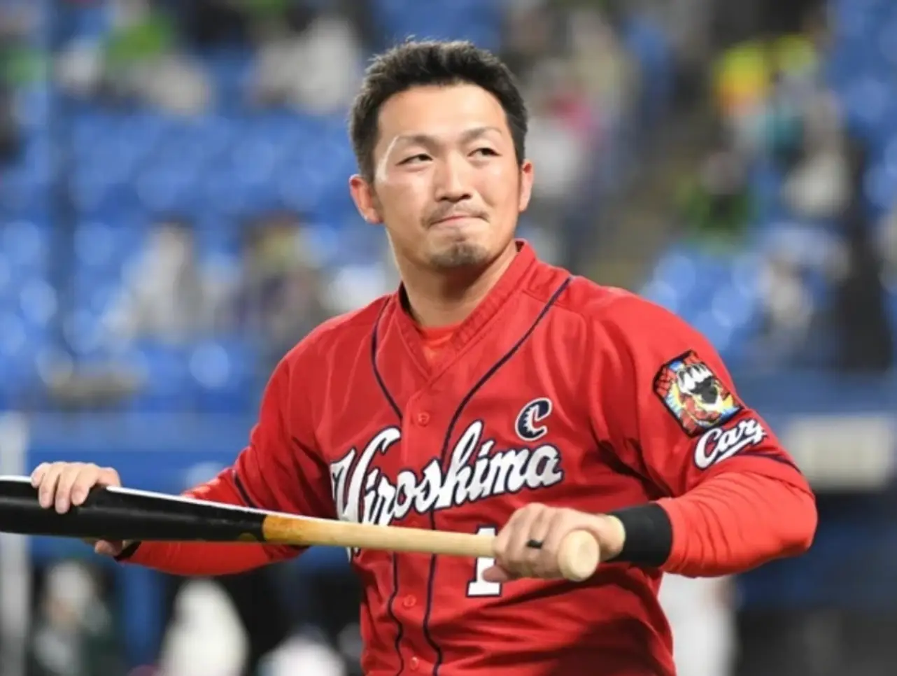 김하성-붉은 유니폼을 입고 야구배트를 두손으로 들고있는 요시다