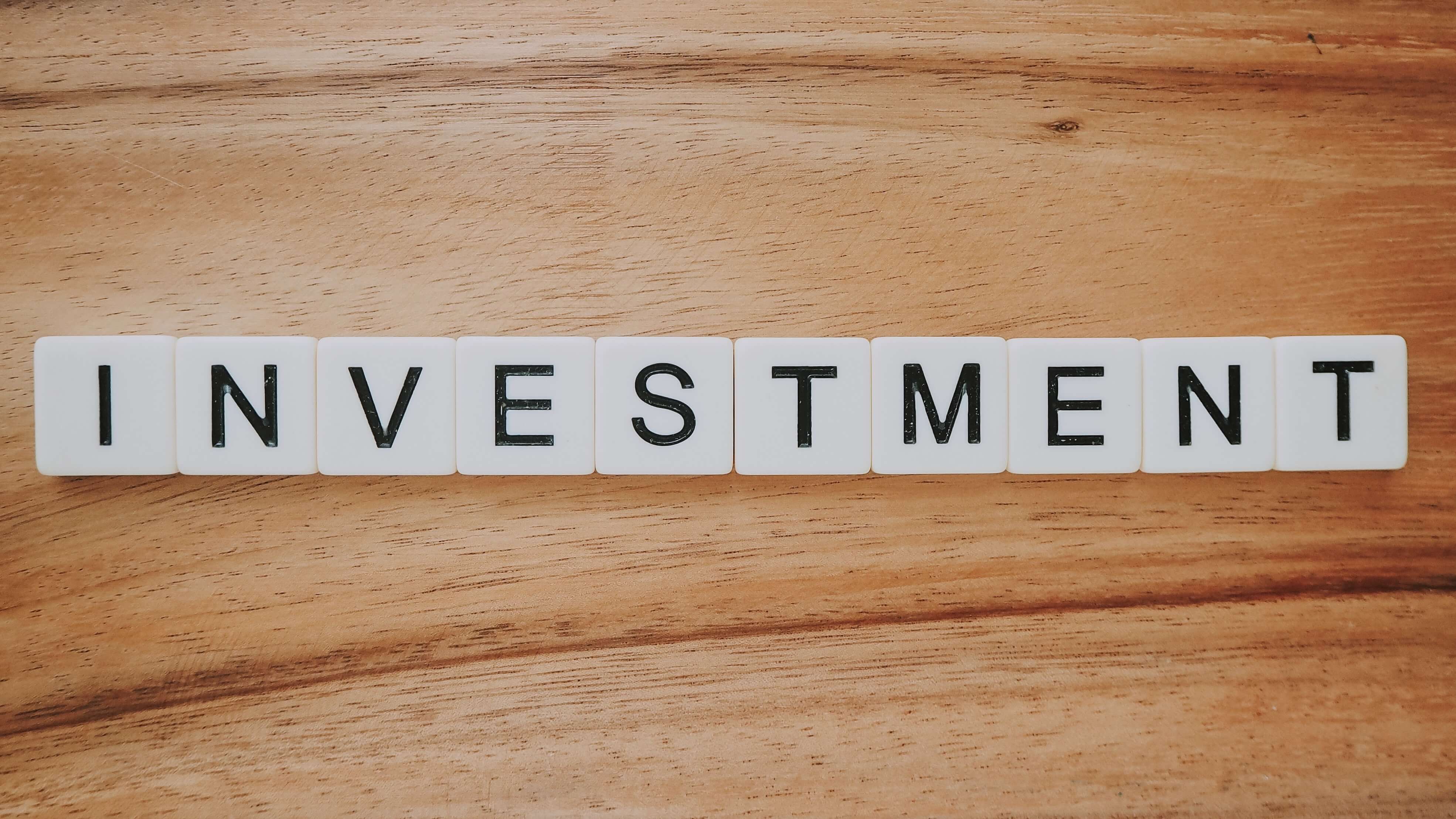 scrabble words that reads 'Investment'