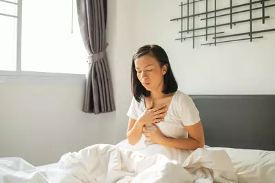woman-white-pajamas-suffering-from-acid-reflux-while-wake-up-her-bed-morning