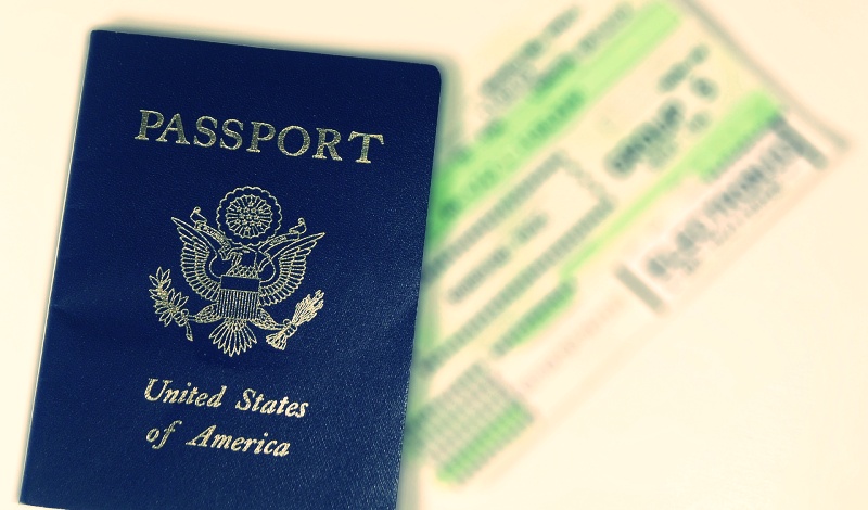 U.S. passport with a blurred visa document in the background, symbolizing international student travel readiness