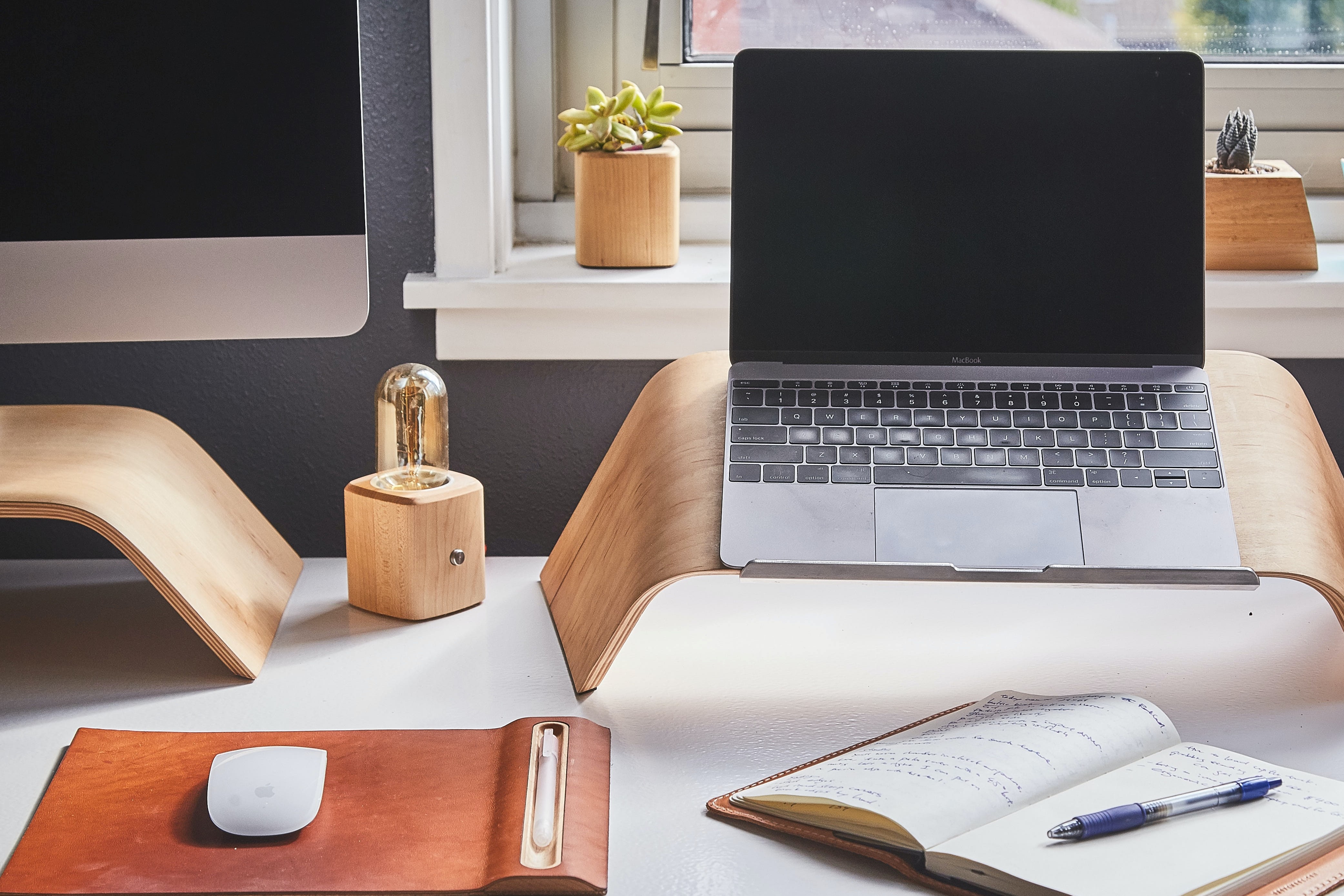 A desk of a home office with a labtop and a desktop PC