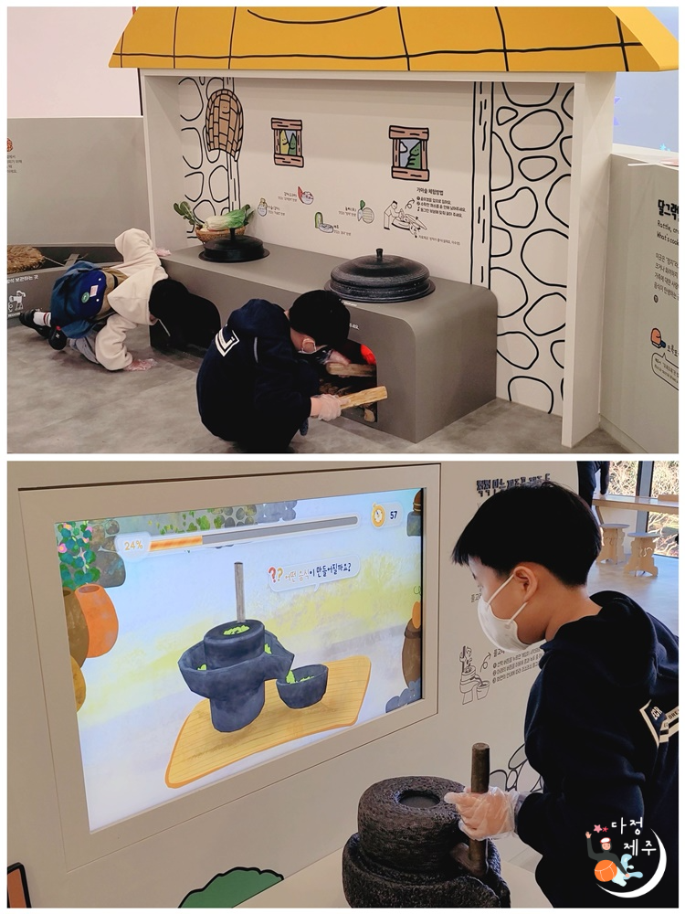 국립제주박물관 어린이박물관 아궁이에 장작 넣는 어린이와 맷돌 손잡이를 돌리는 어린이
