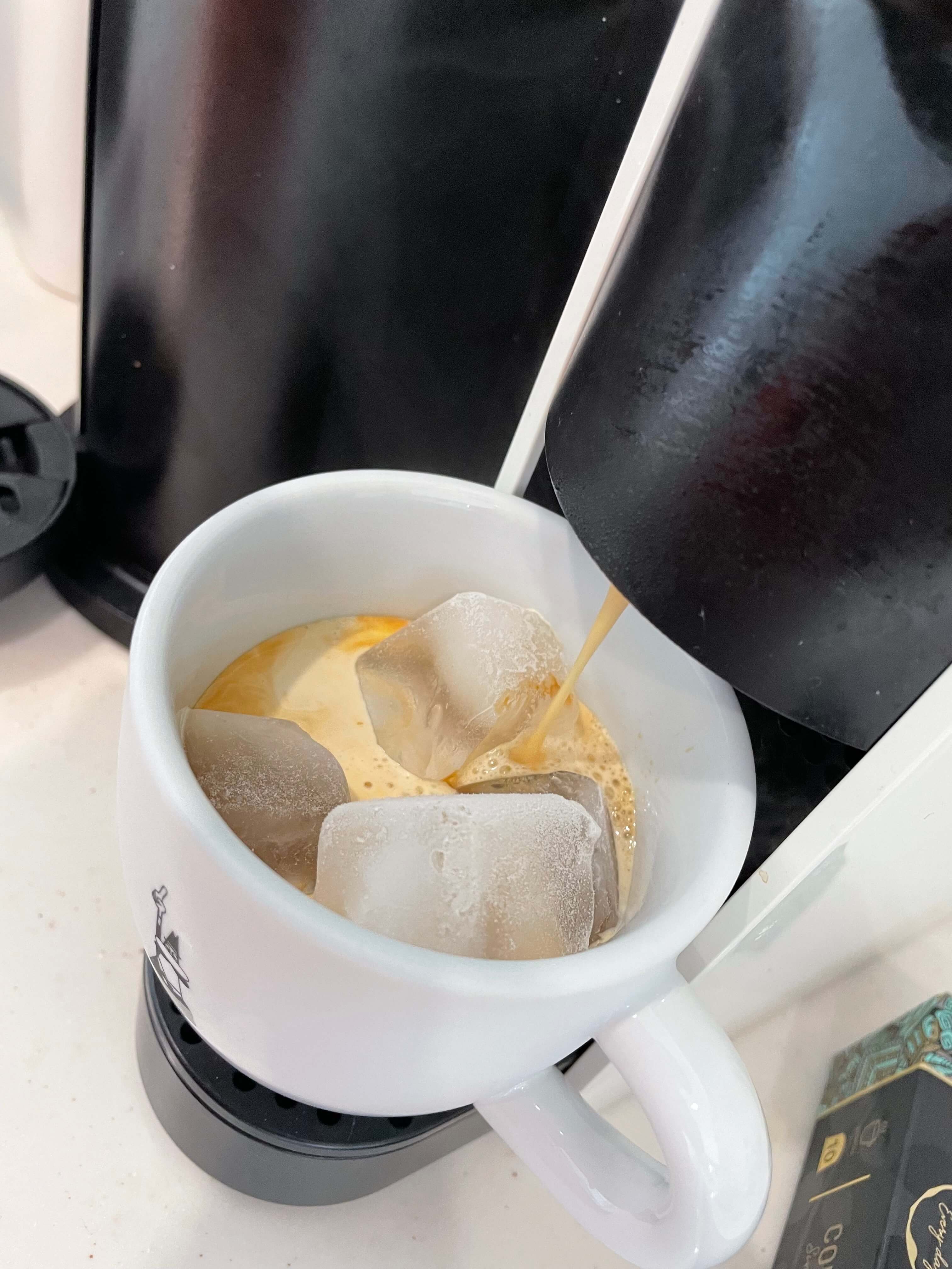 커피가 내려진 후 커피잔에 담겨져 있는 모습 아이스가 머그 컵안에 들어있는 모습. 풍부한 크레마가 보인다.
