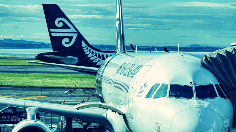 Air New Zealand aircraft docked at an international gate, symbolizing departure for overseas study in Canada