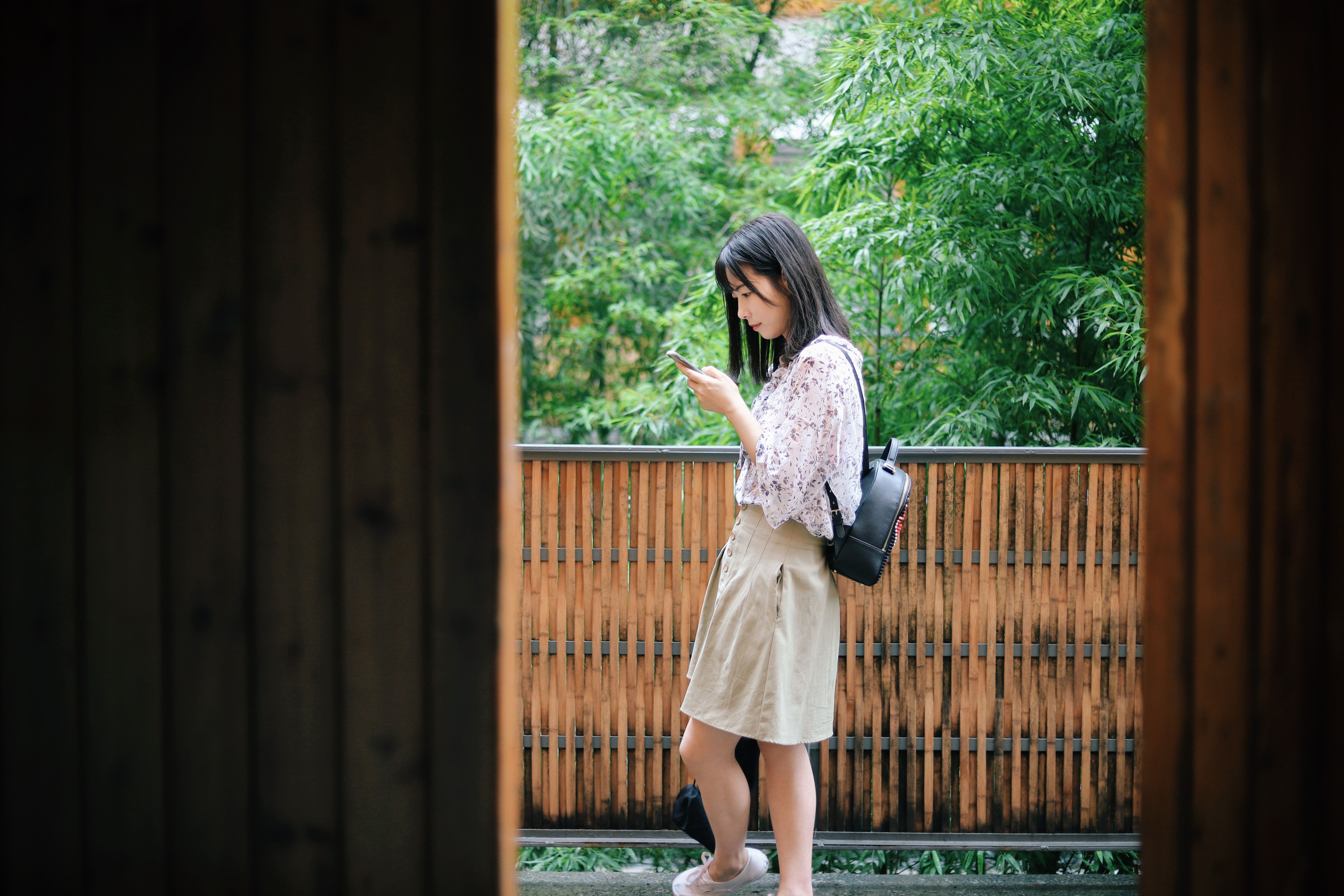 A woman looking at the smartphone screen to see if the phone is not working