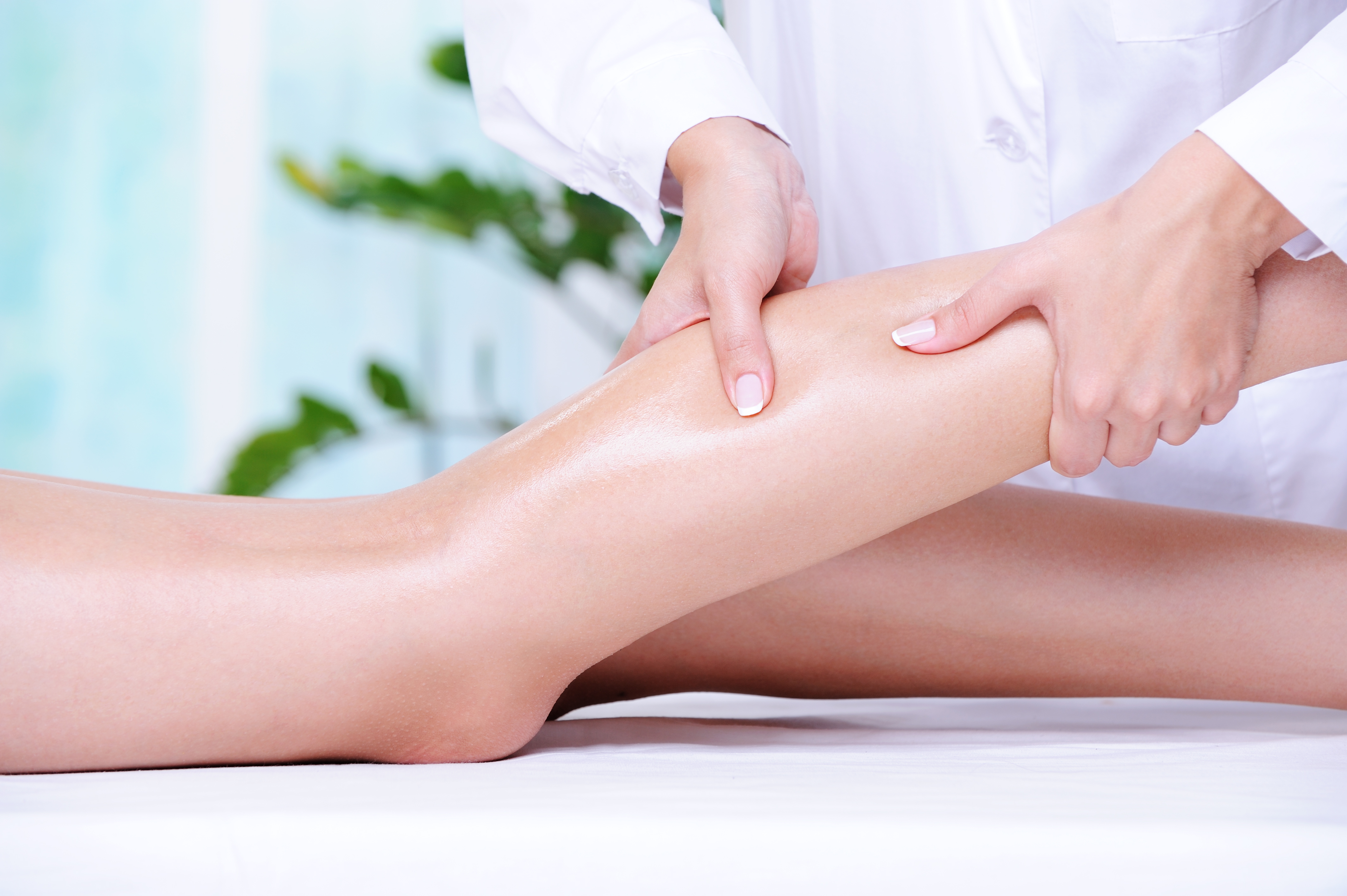 therapeutic-massage-female-beautiful-leg-by-beautician-spa-salon