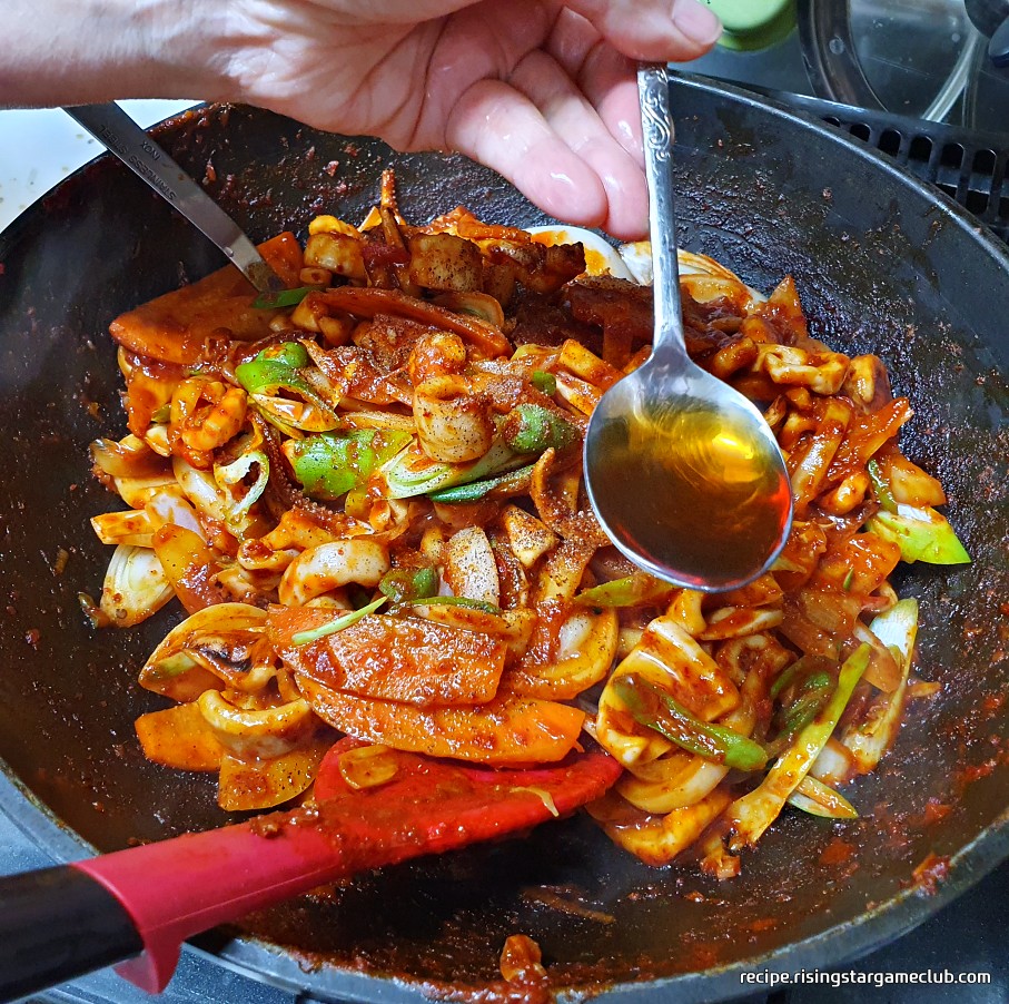 맛있는 오징어볶음에 참기름을 두르는 사진