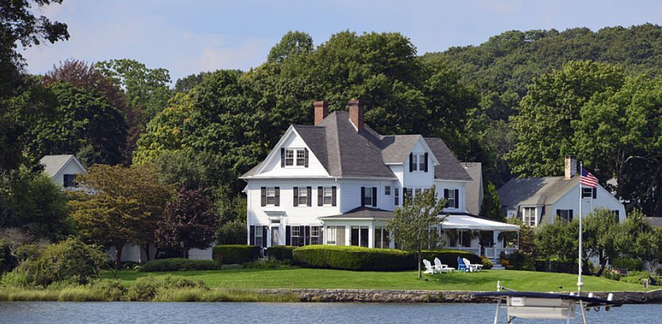 waterfront houses with lush tress