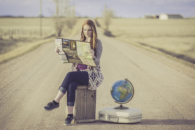 a woman is reading newspaper in the road