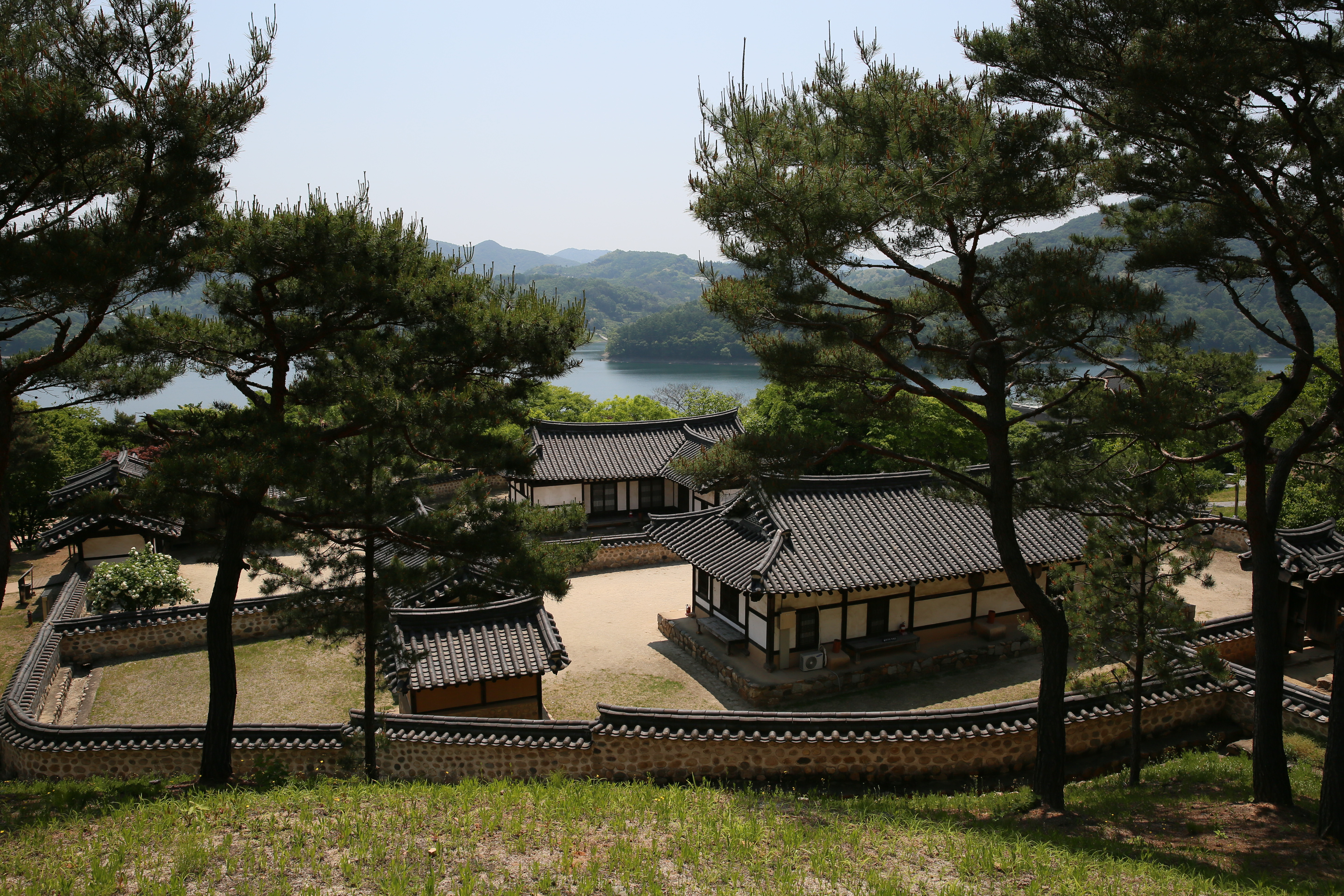 양반가와 대청호반. 바깥채보다 높게 지어진 안채에서 안방마님이 담너머 마당을 내려다 보며 오신 손님을 흘끗흘끗 쳐다보며 &#39;식사 준비를 해야 하나&#44; 아니면 간단한 술상이라도 준비 시켜야 하나?&#39; 생각하는 것만 같다.