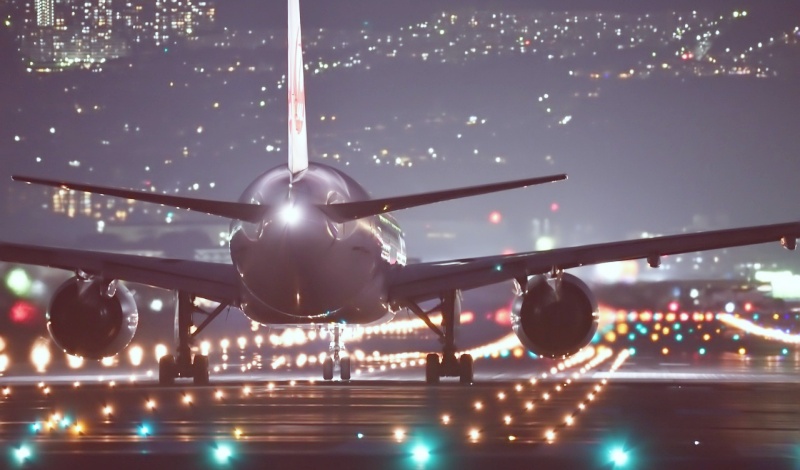 Airplane preparing for departure on a runway at night in the United States