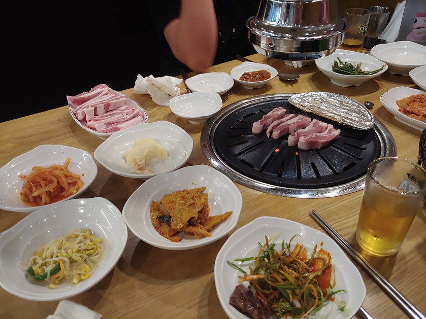 테이블-위에-검정색-불판과-각종-밑반찬