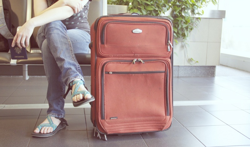 Traveler with Luggage Preparing for U.S. Investment Immigration (EB-5) at Airport