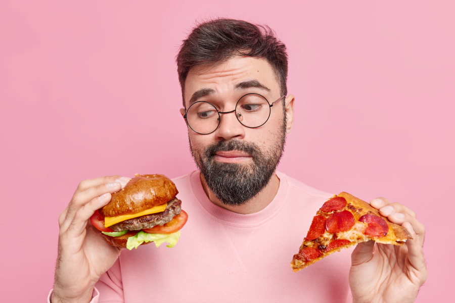 man-feels-hesitant-whether-eat-hamburger-pizza-prefers-eating-junk-food-wears-round-spectacles-jumper-900