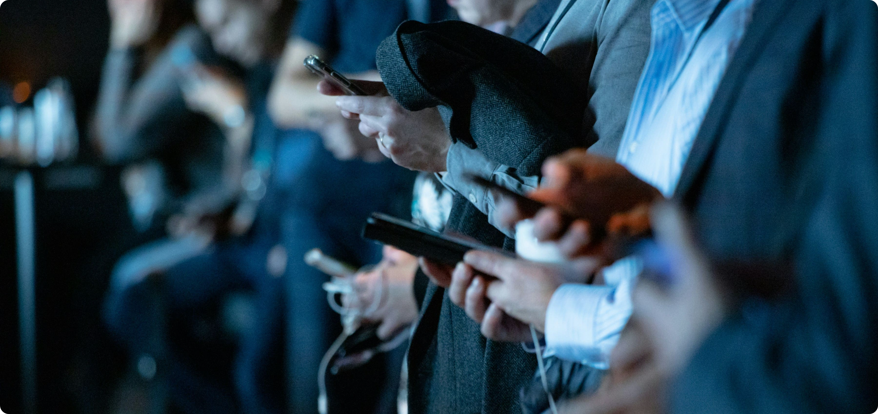 Multiple people looking at smartphones