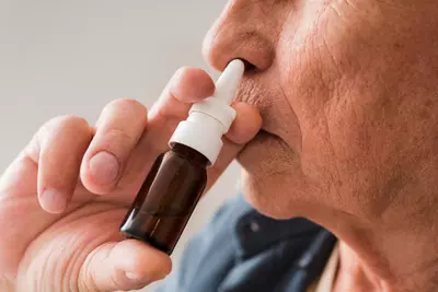 close-up-old-man-using-nasal-spray