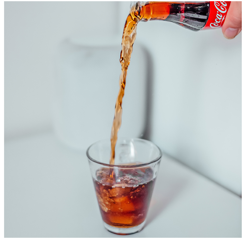 A picture of pouring coke into a cup