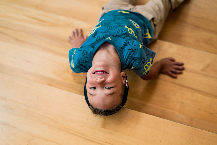 A boy on a floor smiling