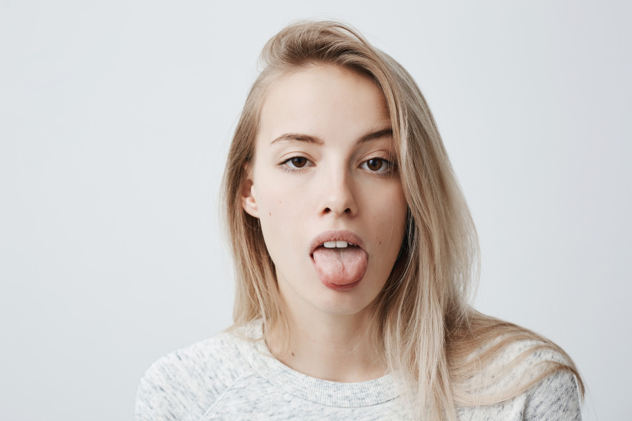 disgusted-pretty-young-woman-with-blonde-hair-sticking-out-tongue-expressing-her-dislike-disregard-towards-something-funny-humorous-female-model-showing-tongue-camera-as-if-teasing-someone-900