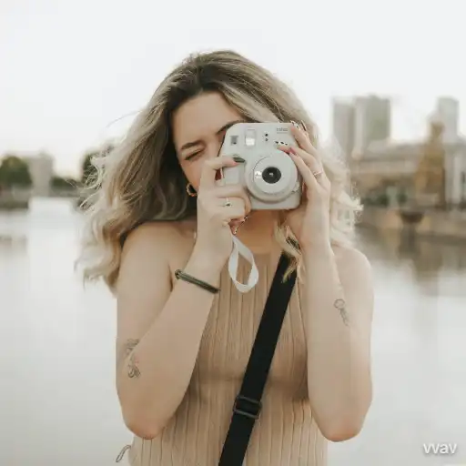 woman taking a polaroid camera