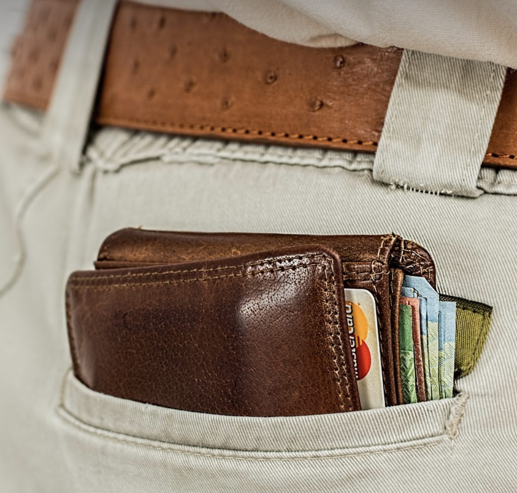 남자 바지 뒷주머니에 신용카드를 많이 꼽은 지갑이 꽂혀있다.
