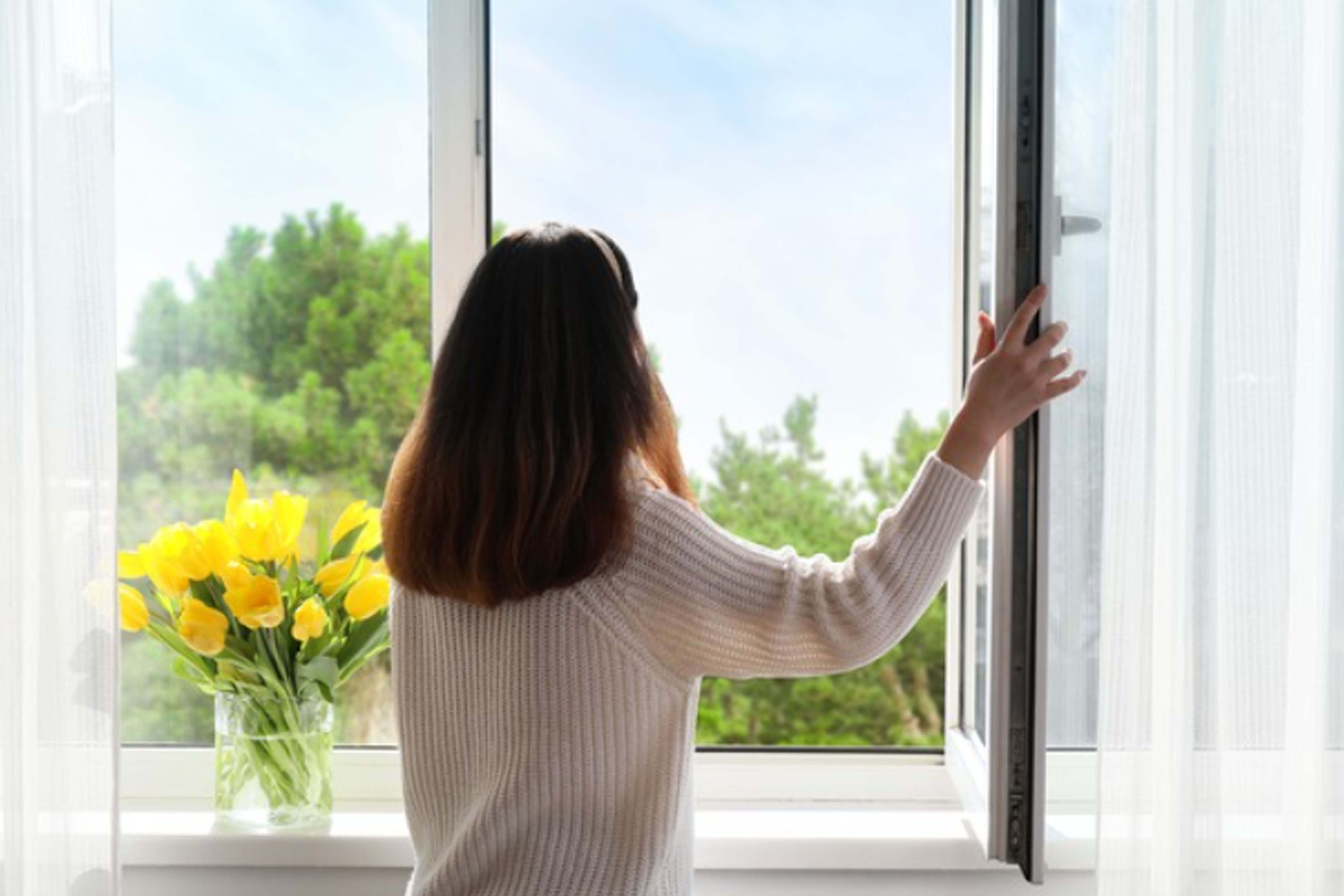 a-person-who-ventilates-a-building-by-opening-a-window.