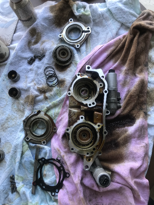 BMW 바노스 유닛 분해 후 내부 부품과 오링 구성품이 바닥에 정리된 리빌트 작업 현장