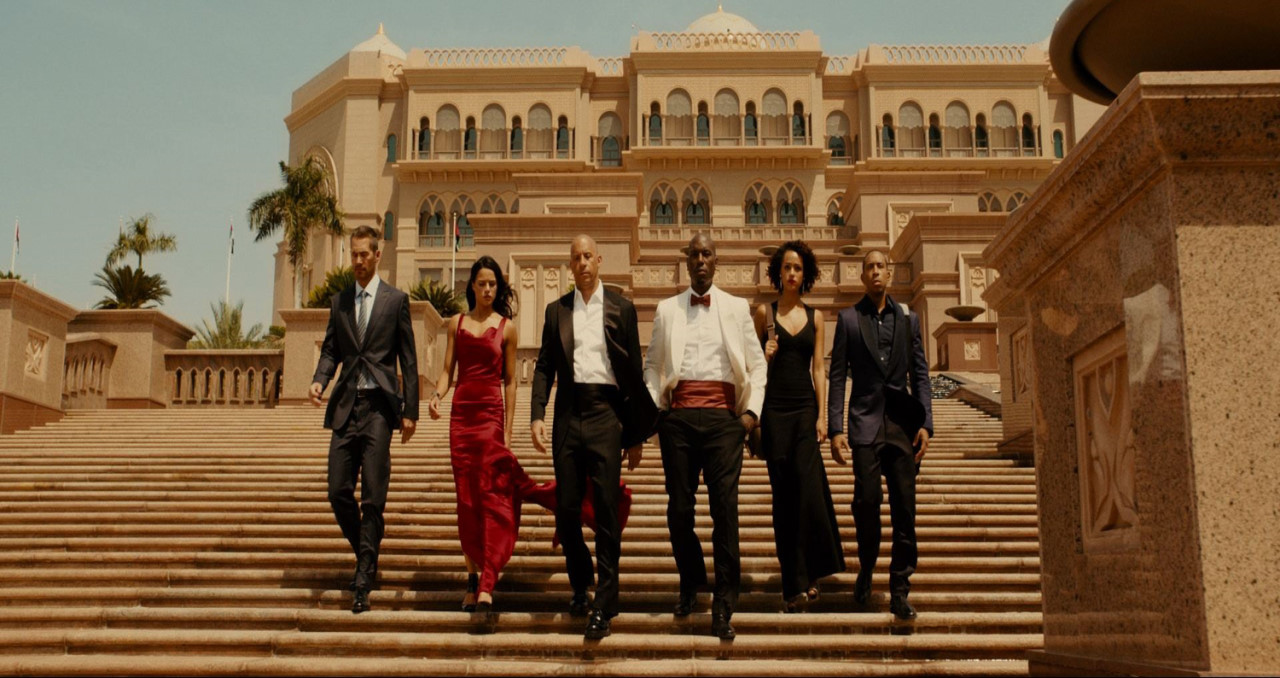 영화의 한장면. 한껏 차려입은 돔과 멤버들이 어디론가 가고 있다.