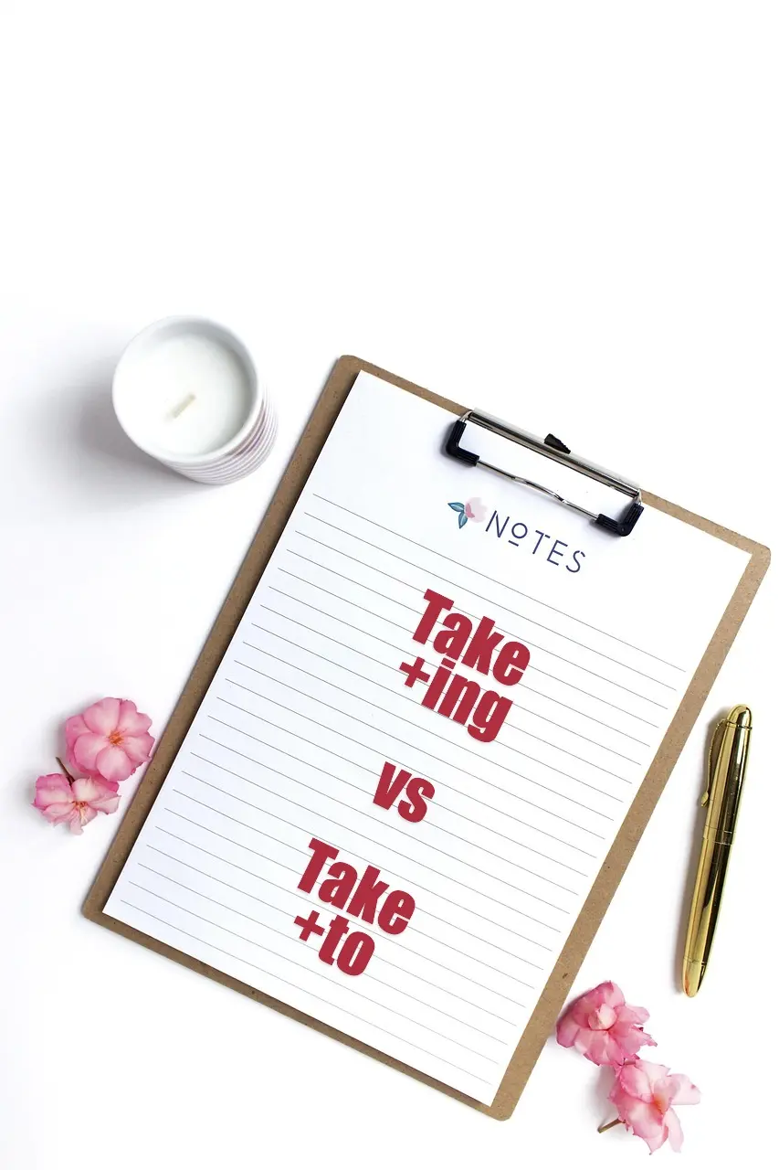 흰-배경위-클립보드에-적힌-Take-+-ing-대-Take-+-to-메모지-옆에는-분홍꽃-흰-촛불-금색-펜