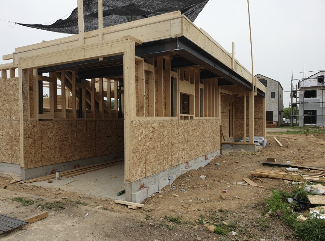 목재로 골조를 세우고 있는 단독주택 시공현장의 모습