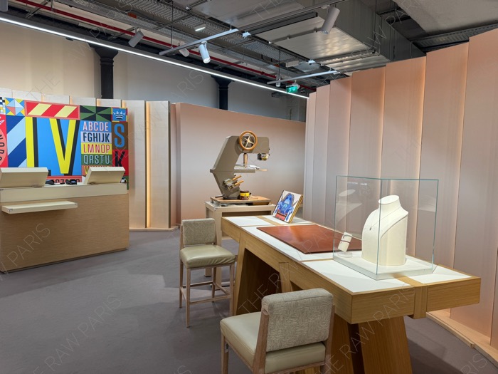The personalized customization desk and jewelry display corner inside LV DREAM store in Paris with personalization machines and colorful graphic walls ❘ Le comptoir de personnalisation et le coin bijoux chez LV DREAM à Paris avec des machines de marquage à chaud