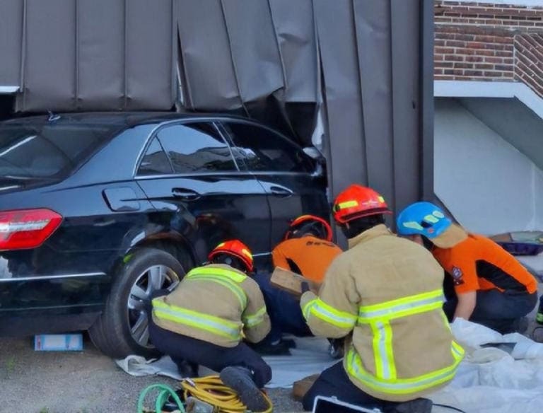Paramedics dealing with a vehicle accident in the front yard