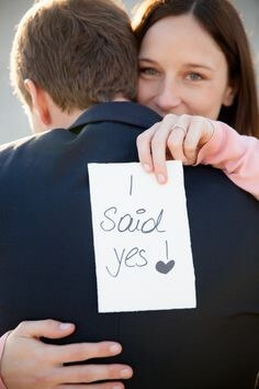 남자의-고백을-받는-분홍티를-입은-여성이-I-SAID-YES가-쓰여진-종이를-들어보이는-모습