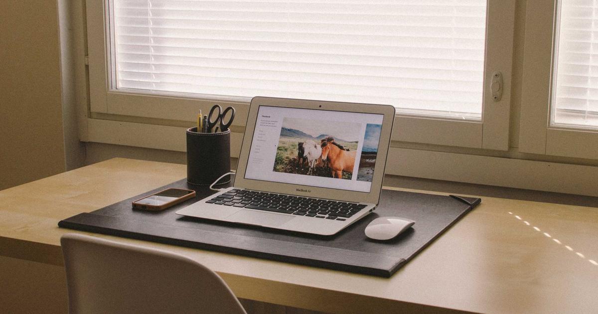 young professional budgeting on laptop with money icons and a piggy bank